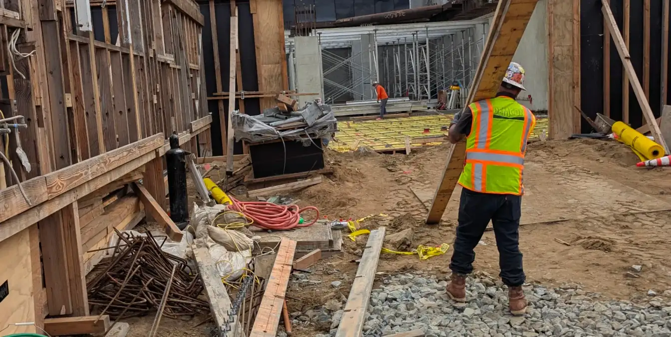 OSHA safety coordinator auditing construction site safety compliance