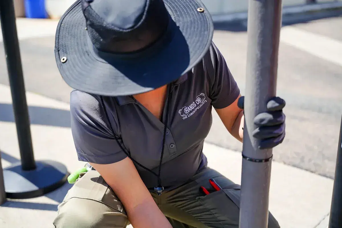 Event support crew setting up steel crowd control barriers